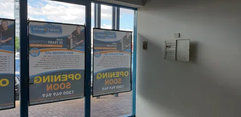 Opening Soon notices displayed on the front windows.