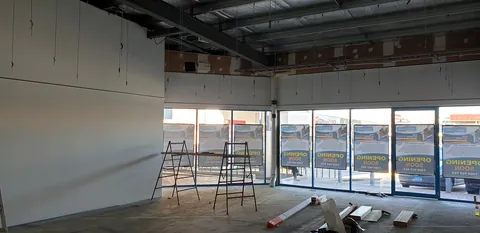 Materials set out across the floor before the partitions are built.