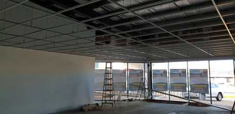 The ceiling grid extending towards the front windows.