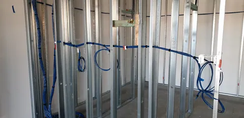 Services routed through the wall framing before lining.