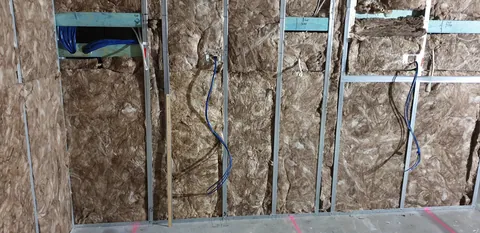 Insulation and service runs before the wall lining covers them.