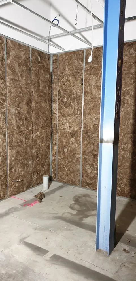 The framed doorway between the insulated rooms.