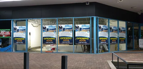 Opening Soon signs across the shopfront windows.