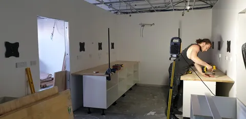 Measuring and assembling the workshop bench cabinetry.