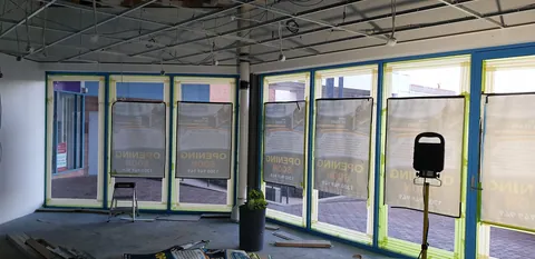 Work continues around the masked front windows.