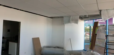The ceiling-panel installation progressing towards the shopfront.