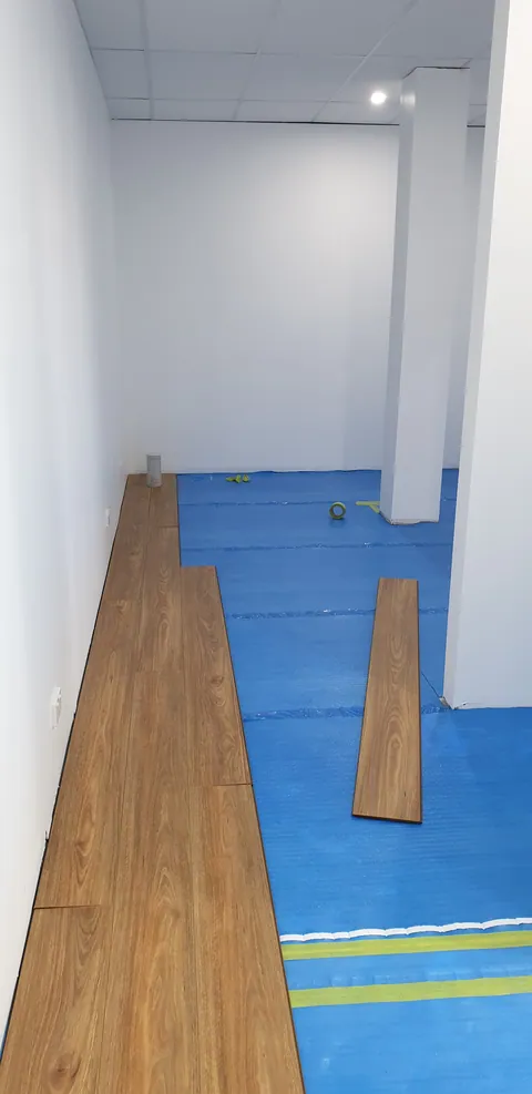 The first floorboards being laid through the passage.