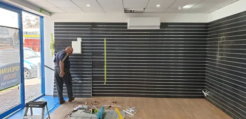 Measuring and fitting the next display-wall section.