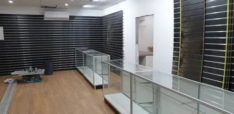 The glass cabinets and retail wall panels coming together.