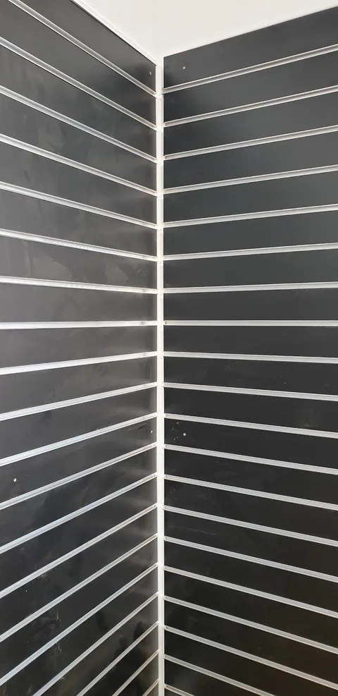 Finishing the joins around the retail wall panels.
