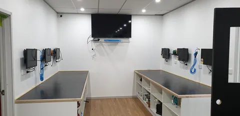 Workshop screens installed above the repair benches.