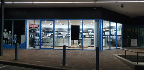 The stocked shopfront illuminated at night.