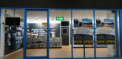 The new shop entrance with its Now Open signs.