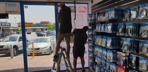 Fitting the tall brand graphic beside the front entrance.